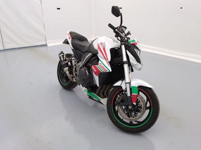 a picture of a white and green motorcycle parked in a room