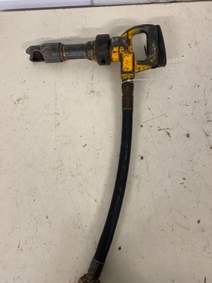 a hose attached to the side of a wall next to a pipe