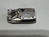 a small piece of metal on a white surface