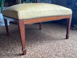 an upholstered bench with a yellow upholstered seat