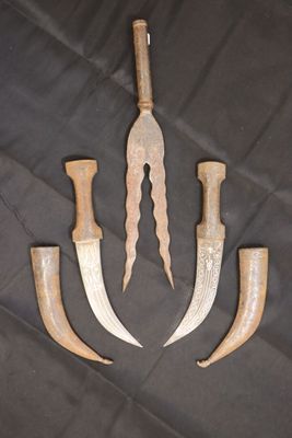 three knives and a knife holder on a black cloth