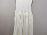 the white dress is hanging on a hanger in a room