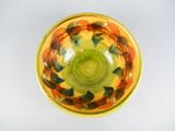 a yellow bowl with fish in it on a white surface