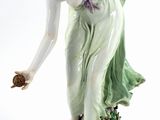 porcelain figurine of a woman holding a flower in her hand
