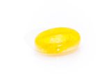 a close up of a yellow jelly on a white surface