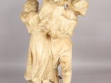 an old statue of a man carrying a child on his back