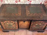 an old wooden table with two drawers on top of it