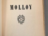 a close up of an open book with the title molloy on it