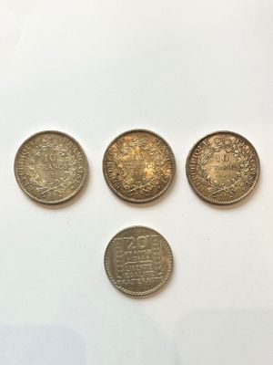 four different types of coins are shown on a white surface