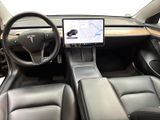 the interior of a tesla vehicle with a touch screen on the dashboard