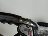 a close up of a bike handle with a clock on it