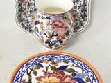 a plate with a cup on it next to a plate with a bowl on it
