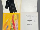 three books are open on a table with a drawing of a man