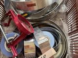 a metal basket filled with different types of kitchen utensils