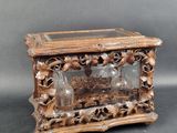 a small wooden box with a glass top on a table