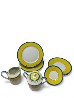 an image of a yellow and blue dinner set with a cup and saucer