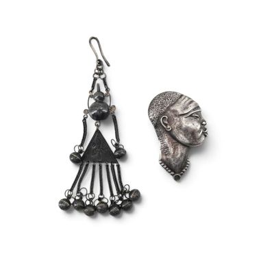 an image of a pair of earrings with a woman ' s face on it