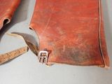 a brown leather bag with a metal buckle on it