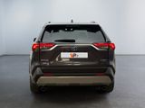 the rear end of a gray toyota rav parked in a room