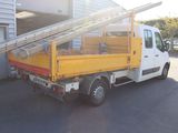 a white truck with a ladder on the back of it