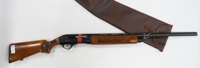 a shotgun and a knife on a white surface