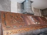 a large copper stove top with a metal chimney