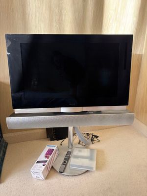 a flat screen tv sitting on top of a desk