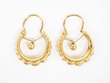 une paire de boucles d'oreilles en or ornées de perles sur fond blanc