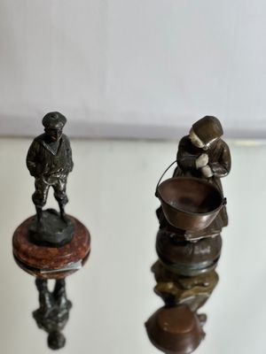 two figurines that are sitting on top of a table