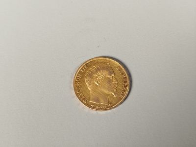 a close up of a gold coin on a white surface