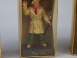 two miniature figurines of a man in a white coat and a man in green pants