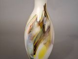 a white vase with a multicolored design on it