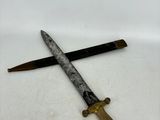 a knife that is laying on the ground next to a knife