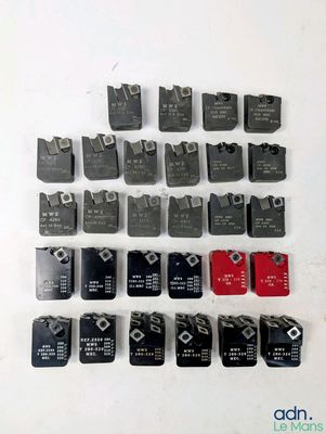 a close up of a bunch of electrical switches on a white surface