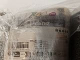 two rolls of yarn wrapped in plastic on a table