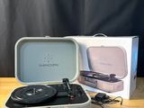 a suitcase with a record player in it sitting on a table