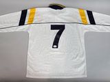 a white hockey jersey with the number 7 on it