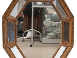 a mirror that is sitting on the floor in front of a chair