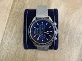 a close up of a watch sitting on a table on a cloth