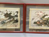 two framed pictures of birds and flowers in a red frame