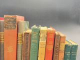 several old books are stacked on top of each other on a table