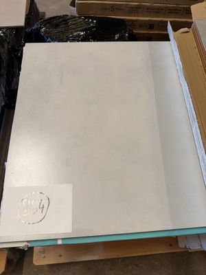 a stack of boxes and boxes of paper on the floor