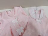 a pink shirt and a pink dress on a white table