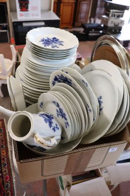 a box full of plates and cups on a table