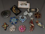 Diverses broches et boucles d'oreilles vintage sont exposées sur une table