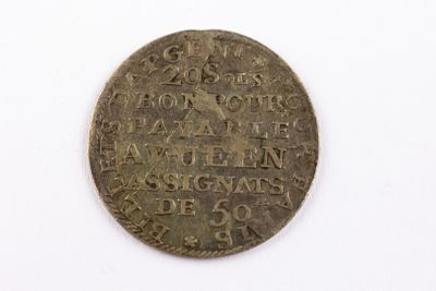 a close up of a coin on a white surface