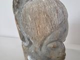 sculpture of a woman ' s head on a white surface
