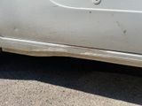 a white car that has been left on the street
