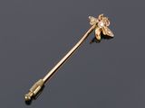 a gold and diamond flower broochle pin