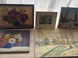three paintings on a table with a vase of flowers